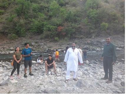 Team near Himalayan stream